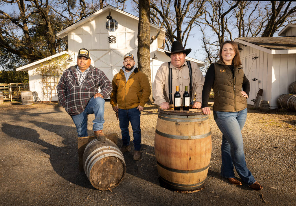 From right, Taylor Serres and her father John with Richard and his father Gabino Ramirez, who has worked for Serres Ranch In Sonoma for over 30 years, Friday, March 3, 2023. (John Burgess / The Press Democrat)