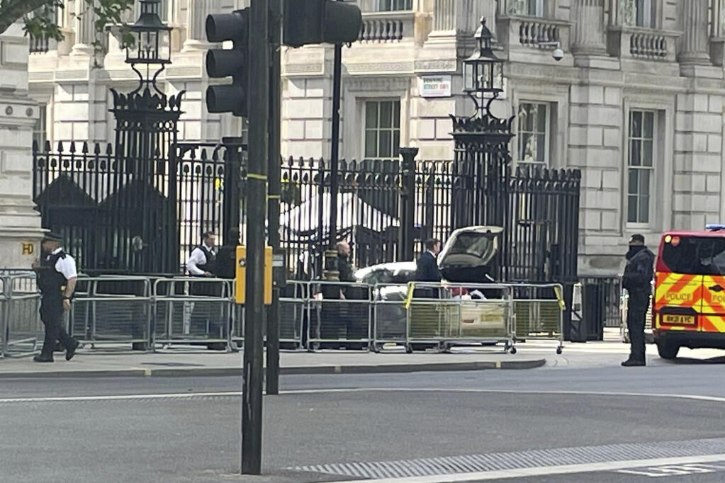 Police at the scene after a car collided with the gates of Downing Street in London Thursday May 25, 2023. Police say a car has collided with the gates of Downing Street in central London, where the British prime minister's home and offices are located. The Metropolitan Police force said there were no reports of injuries. (Ben Hatton/PA via AP)