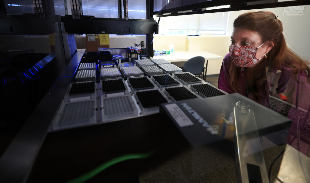 In this file photo, a Sonoma County Health microbiologist checks the progress of genetic sequencing for COVID testing samples(Kent Porter / The Press Democrat) 2021