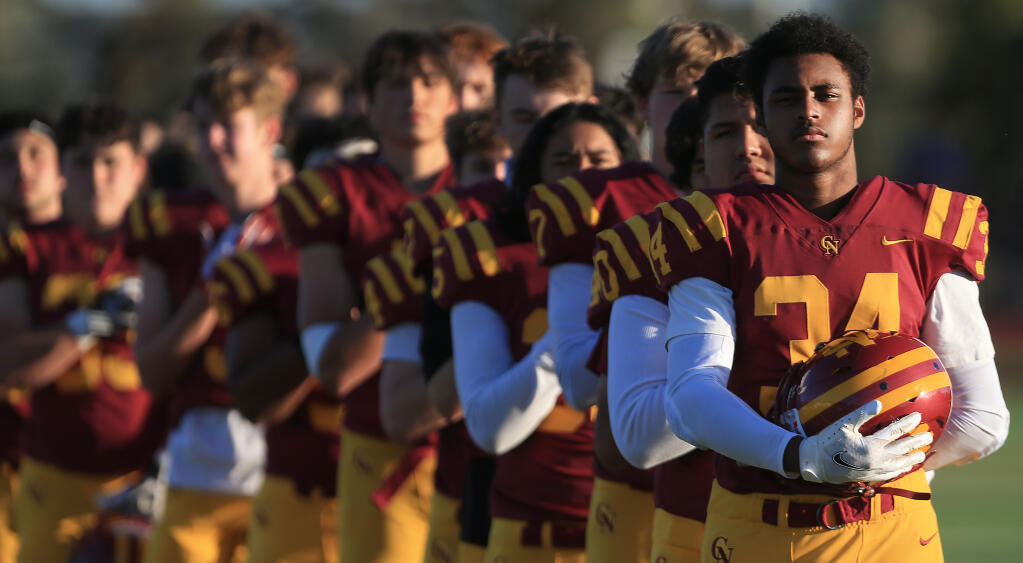 Cardinal Newman players stand for the National Anthem prior to their game with the Rancho Cotate Cougars at Cardinal Newman High School, Tuesday, March 30, 2021 in Santa Rosa. (Kent Porter / The Press Democrat) 2021