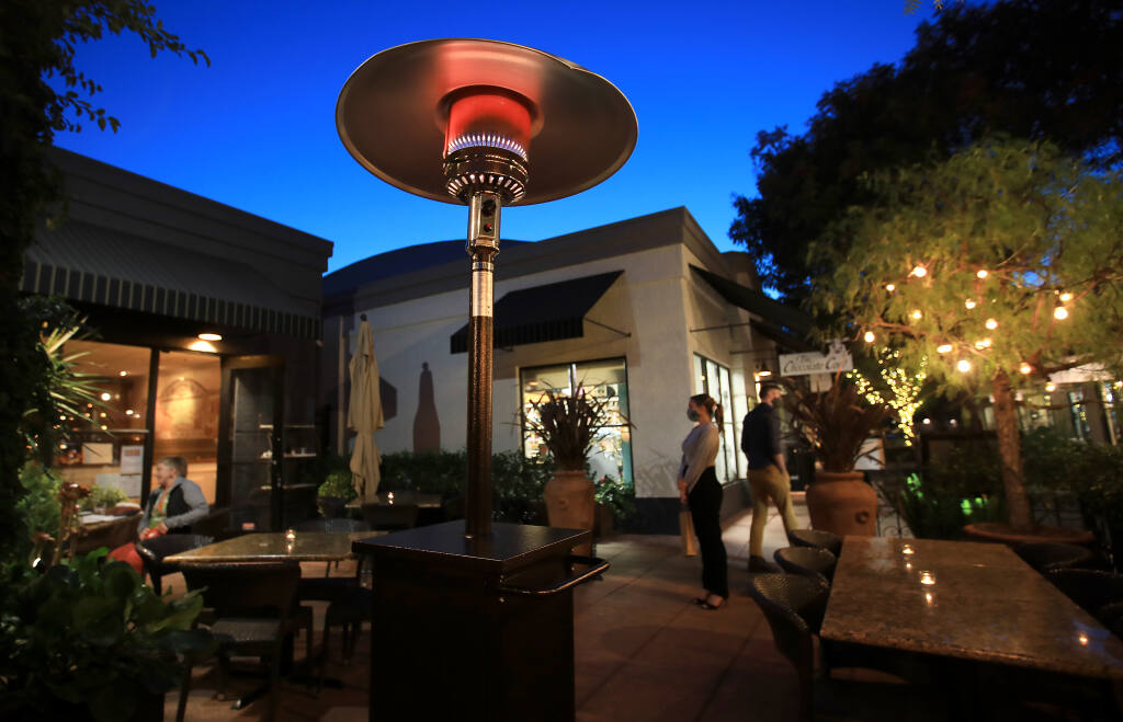 Night falls on the outdoor patio at LaSalette in Sonoma as a patio heater warms the air, Monday, Nov. 2, 2020. (Kent Porter / The Press Democrat) 2020