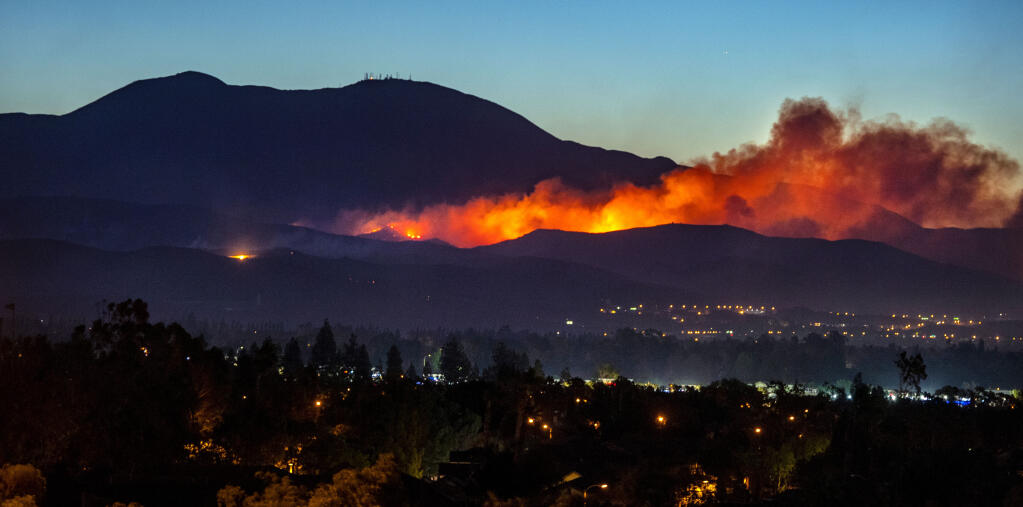 With Modjeska Peak and Santiago Peak as a backdrop, the Silverado Fire continues to burn in the canyons east of the city of Irvine before dawn on Tuesday, October 27, 2020. (Photo by Mark Rightmire, Orange County Register/SCNG)