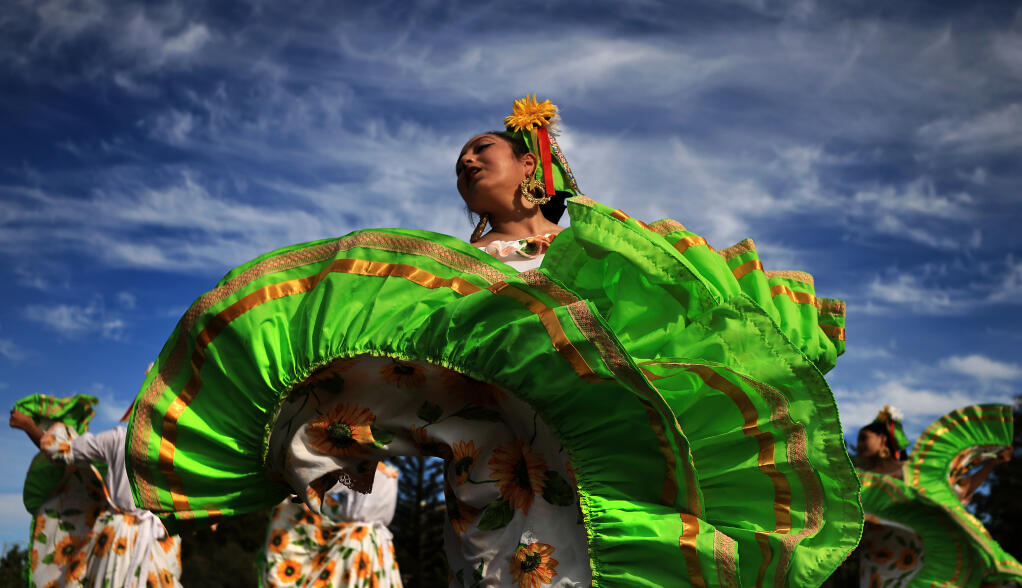 Andrea Morales, 14, of the Ballet-Folklorico Netzahualcoyotl, performs during the unveiling of The Marylou Lowrider Project, a Santa Rosa Police Department patrol car dedicated to Marylou Armer, Saturday, March 26, 2022 in Santa Rosa.   (Kent Porter / The Press Democrat) 2022