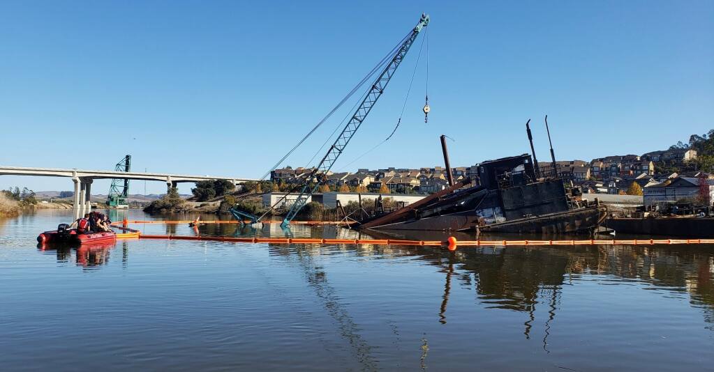 Fire crews put containment booms around fluid spill after tides partially inundate barge in Petaluma River on Sunday, Nov. 15, 2020. (Chad Costa/Petaluma Fire Department)