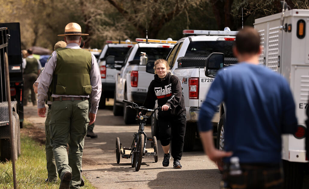 Ashley Jones navigates through Sonoma County Regional Park rangers, Thursday March 23, 2023 after moving out of her encampment on the Joe Rodota Trail as the county clears homeless encampments. (Kent Porter / The Press Democrat) 2023