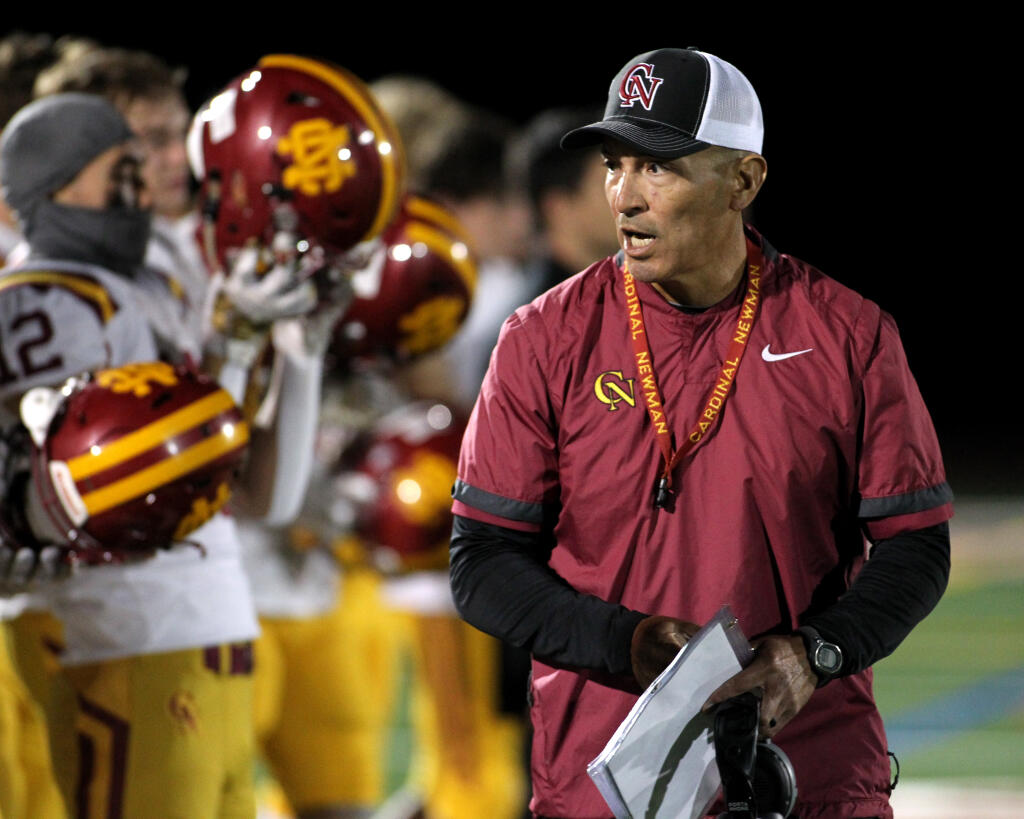 Cardinal Newman head coach Richard Sanchez talks to players at the start of the game against Rancho Cotate in Rohnert Park on Friday, Oct. 29, 2021. (Darryl Bush / For The Press Democrat)