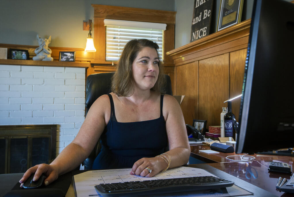 Mortgage specialist Jennifer Brown, of Crosscountry Mortgage, shown here at her office on Broadway, says the industry is in ’boom’ mode. (Photo by Robbi Pengelly/Index-Tribune)