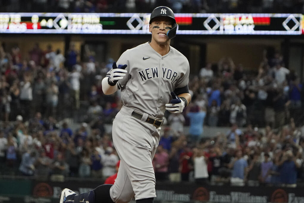 The New York Yankees’ Aaron Judge gestures as he runs the bases after hitting a solo home run, his 62nd of the season, during the first inning against the Rangers in Arlington, Texas, Tuesday, Oct. 4, 2022. (LM Otero / ASSOCIATED PRESS)
