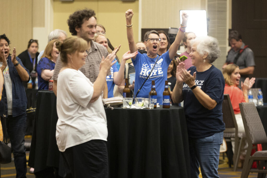 Abortion-rights supporters rejoice as early polls indicate the proposed constitutional amendment in Kansas has not passed late Tuesday, Aug. 2, 2022, at a Kansans for Constitutional Freedom election watch party at the Overland Park Convention Center in Overland Park, Kan. (Evert Nelson/The Topeka Capital-Journal via AP)