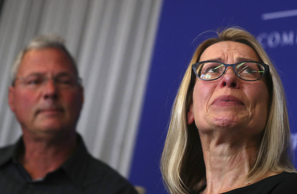John Bauer, left, and his wife, Rose Bauer, speak to the media on Thursday, June 20, 2019, in Oakland, Calif.  The family's attorney said Tuesday, Aug. 10, 2021, the Northern California city of Pleasanton agreed to pay nearly $6 million to settle a lawsuit with the family whose mentally ill son, Jacob Bauer, died in 2018 after police restrained and repeatedly tasered him. (Aric Crabb/Bay Area News Group via AP)