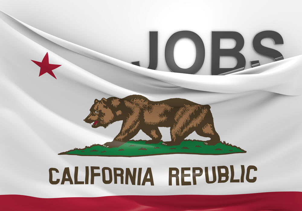 Concept image of the California flag with the top right pulled down to reveal the word "JOBS."