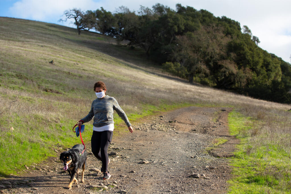 Pearla Castillo walks her dog Hercules on the Western Route trail at Taylor Mountain Regional Park in Santa Rosa on Wednesday, Dec. 30, 2020. (Alvin A.H. Jornada / The Press Democrat)