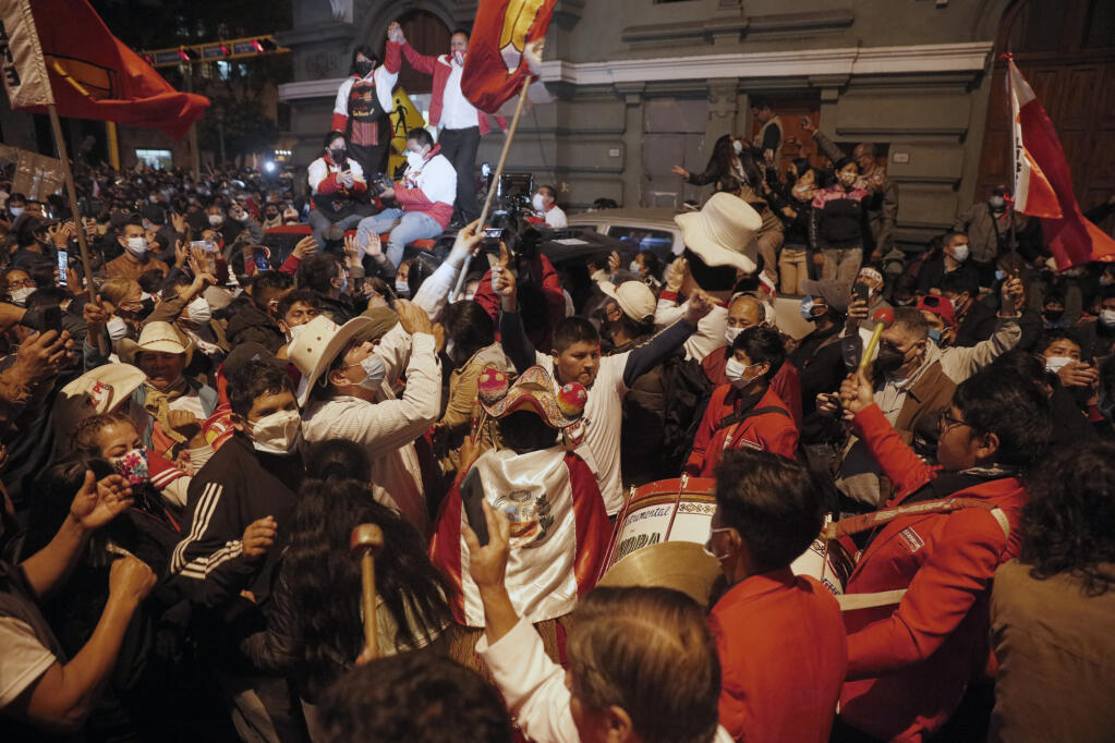 Supporters of Pedro Castillo celebrate after he was declared president-elect of Peru by the election authorities, in Lima Peru, Monday, July 19, 2021. Castillo was declared president-elect more than a month after the elections took place and after opponent Keiko Fujimori claimed that the election was tainted by fraud. (AP Photo/Guadalupe Prado)