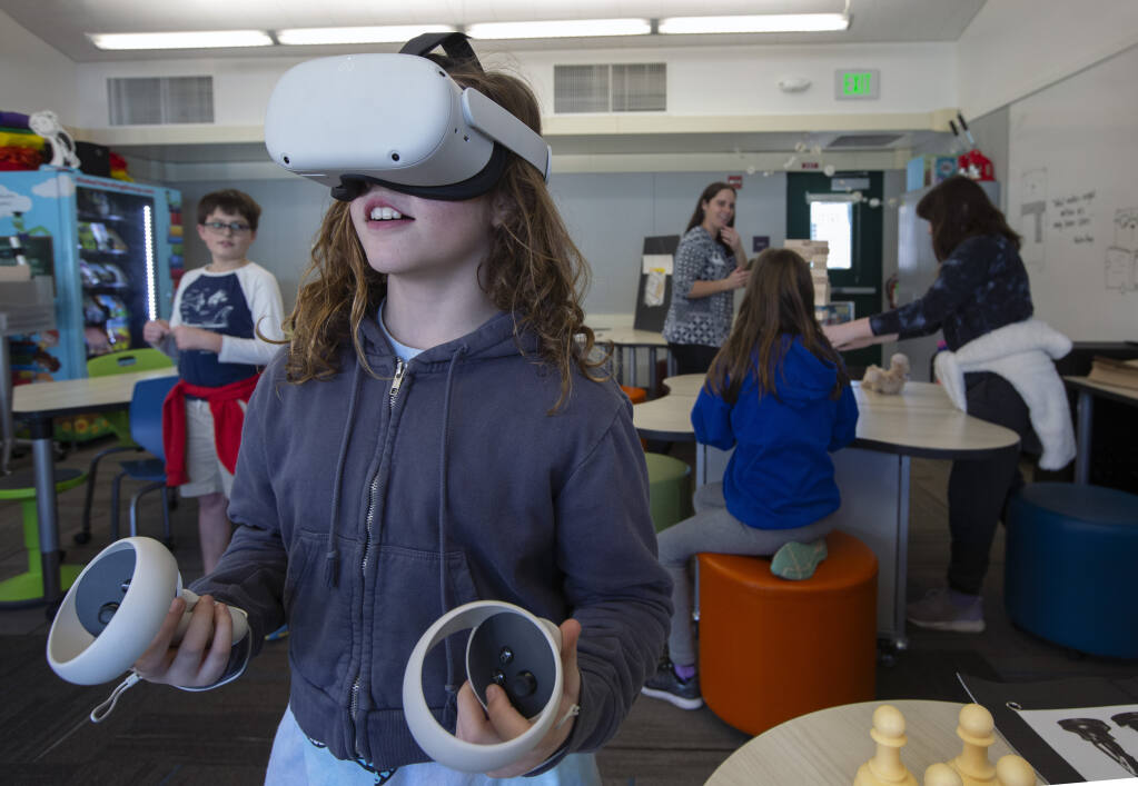 Olivia Ryan, 9, is amazed to see Jupiter in the VR headset In the Flowery Elementary School library on Tuesday, Jan. 24, 2023. (Robbi Pengelly/Index-Tribune)