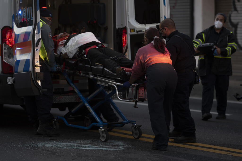 First responders give medical assistance to a driver on R.H. Tood Avenue after a car crash near an intersection during a blackout in San Juan, Puerto Rico, early Thursday, April 7, 2022. More than a million customers in Puerto Rico remained without electricity on Thursday after a fire at a main power plant caused the biggest blackout so far this year across the U.S. territory, forcing it to cancel classes and shutter government offices. (AP Photo/Carlos Giusti)