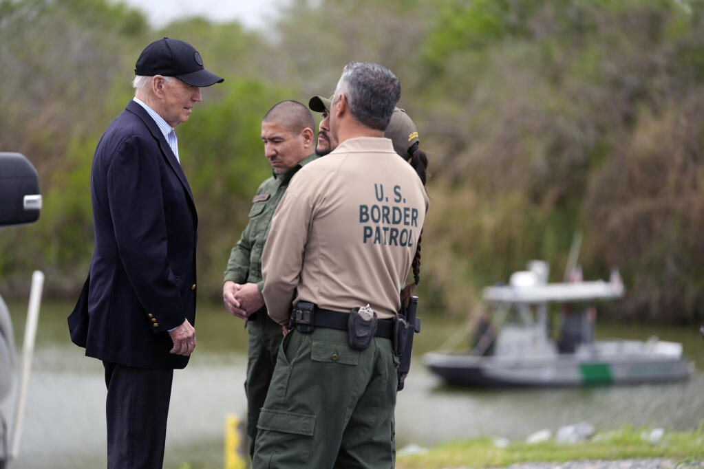 President Joe Biden talks with U.S. Border Patrol officers during a Feb. 29 visit to the southern border. (EVAN VUCCI / Associated Press)