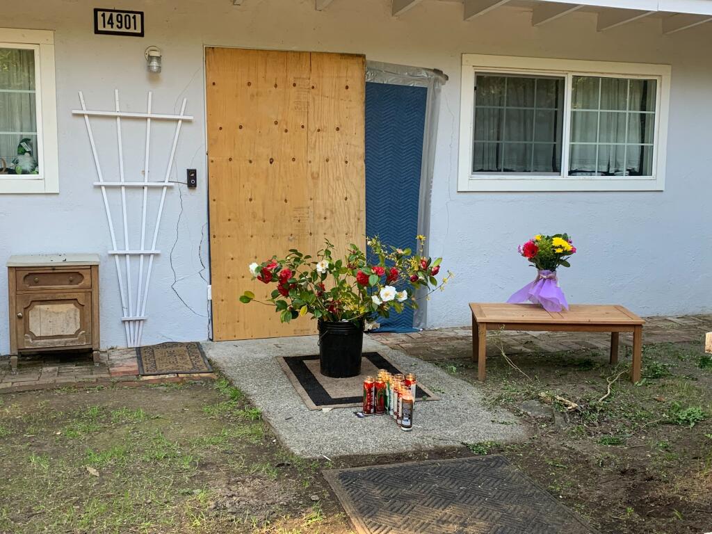 A memorial was set up Friday in front of the house on Old Cazadero Road in Guerneville where the first attack happened, Wednesday. (Colin Atagi / The Press Democrat)