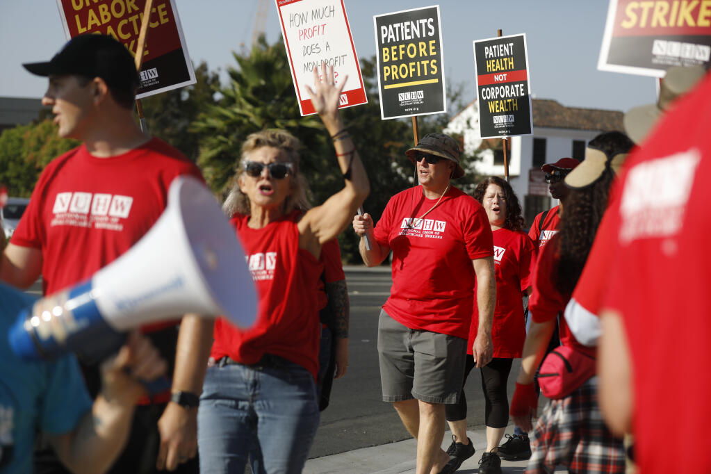 Licensed Marriage and Family Therapist Tony Crain, center, joins with other Kaiser Permanente mental health workers on the picket line at the Kaiser Permanente Santa Rosa Medical Center in Santa Rosa, California, on Tuesday, Aug. 16, 2022. (Beth Schlanker/The Press Democrat)