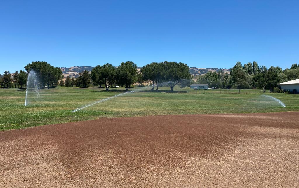 Sprinklers blast water onto the grass at Prince Park in east Petaluma shortly after noon on Tuesday, June 15, 2021. Residents questioned the city’s irrigation timing, which contradicted guidance city officials put out to stem impacts from the ongoing drought. (EMILY CHARRIER/ARGUS-COURIER STAFF)