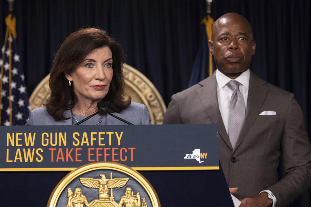 New York Gov.  Kathy Hochul, left, and New York City Mayor Eric Adams, right, attend a news conference about upcoming “Gun Free Zone" implementation at Times Square, Wednesday, Aug. 31, 2022, in New York. (AP Photo/Yuki Iwamura)