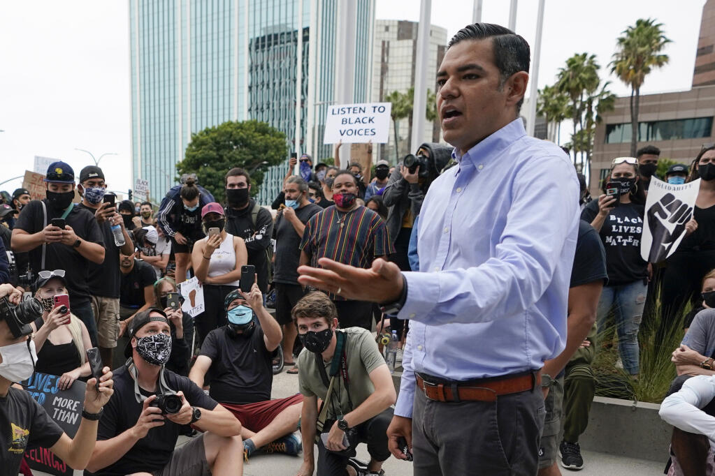 FILE - Robert Garcia, the mayor of Long Beach, Calif., speaks to demonstrators outside Long Beach City Hall on June 4, 2020, in Long Beach, Calif. Garcia has already announced plans to run in the newly created district in the Long Beach area. Incumbent Reps. Alan Lowenthal and Lucille Roybal-Allard, who both represent parts of the newly drawn district, have both said they will not seek re-election. California's citizens redistricting commission finalized new political maps on Monday, Dec. 20, 2021. (AP Photo/Ashley Landis, File)