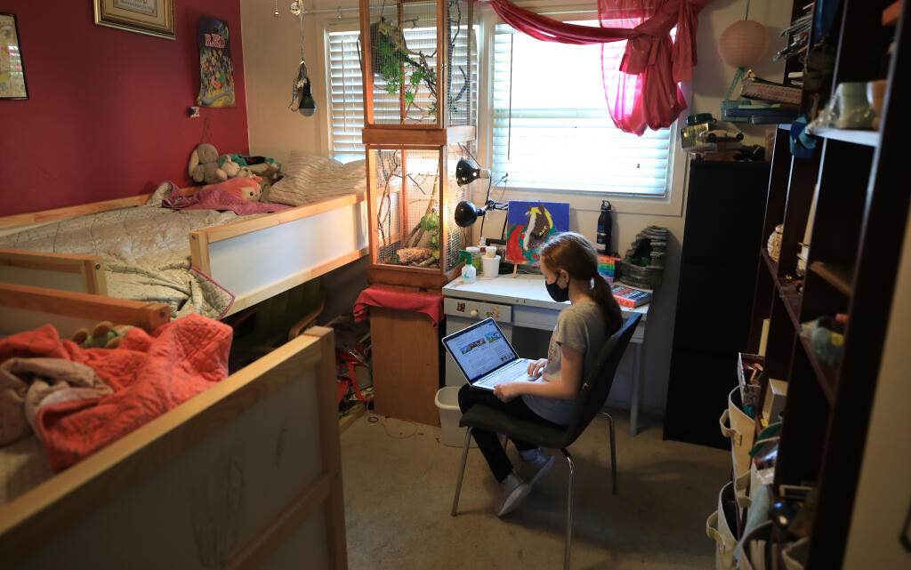 Charlotte Wood, 10, takes a break from her two sisters to get quiet time in her room as she prepares for the coming school year, Tuesday, Aug. 11, 2020, in Santa Rosa. (Kent Porter / The Press Democrat) 2020