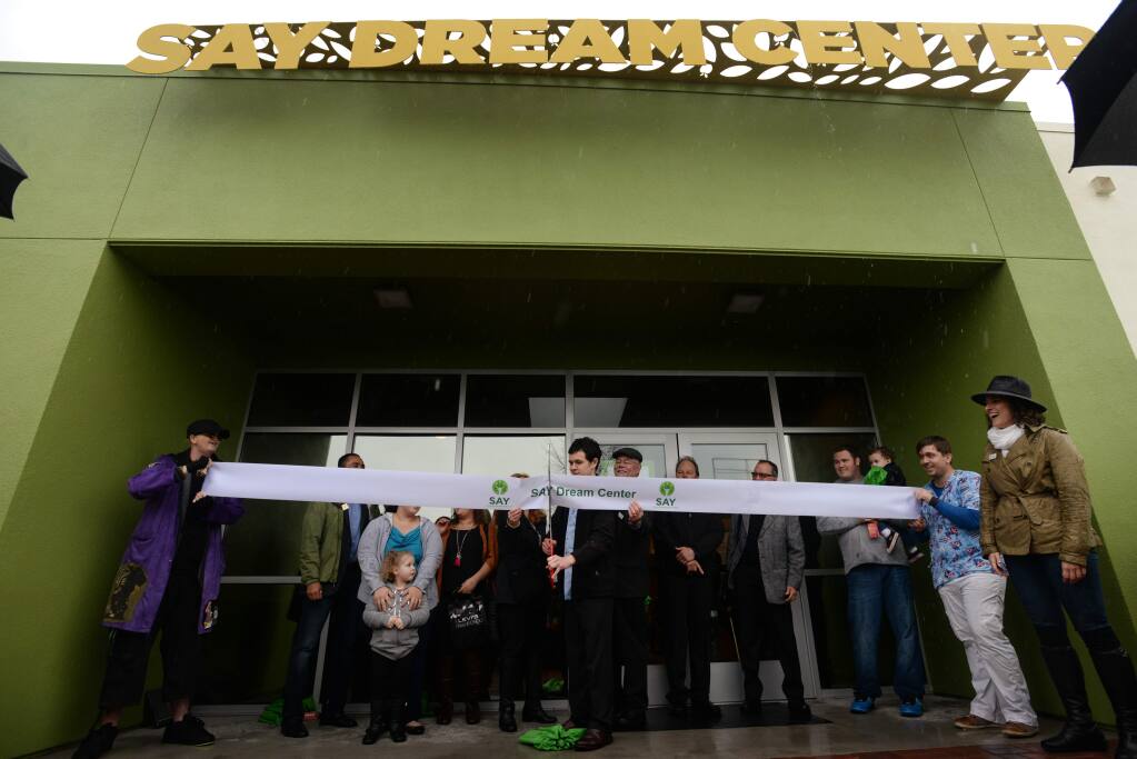 Cameron Vadnais, a formerly homeless youth, cuts the ribbon to open Social Advocate’s for Youth’s Dream Center in 2016. (ERIK CASTRO / For The Press Democrat)