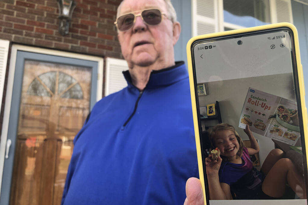 Retiree Andy Roberts displays a photo of his daughter, 5-year-old Tesla, at his home Thursday, Jan. 13, 2022, in St. Albans, W.Va. For the first time in half a year, families on Jan. 14, are going without a monthly deposit from the federal child tax credit. Roberts relied on the check to help raise his two young grandchildren, whom he and his wife adopted. (AP Photo/John Raby)