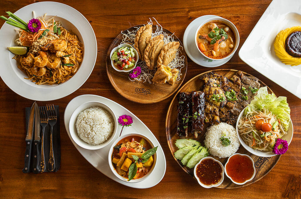 Clockwise from bottom right, Special BBQ combo with chicken, pork, beef and ribs, Pumpkin Curry, Pad Thai, Potato Samosas, Tom Yum Soup and Mango Sticky Rice from Osha Thai BBQ in Petaluma on Friday, Jan. 16, 2022. (John Burgess/The Press Democrat)