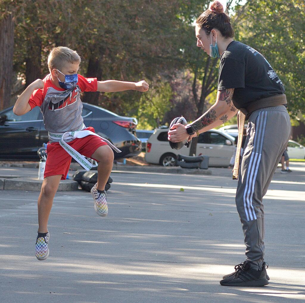 Instructor Kaylee Baum works with a young student  at Schafer’s Martial Arts. (SUMNER FOWLER / FOR THE ARGUS-COURIER)