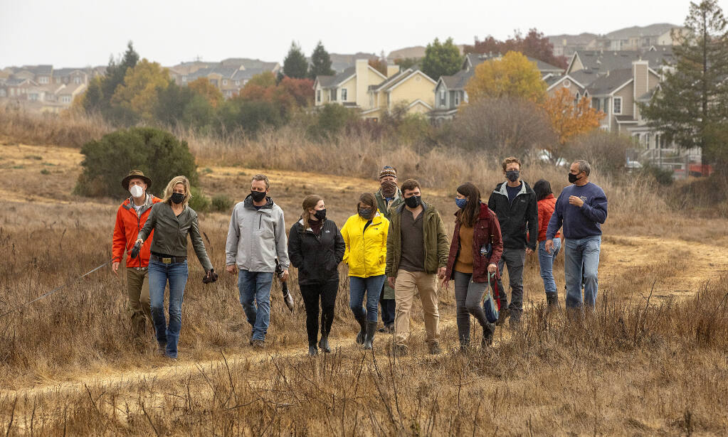 The Petaluma River Park Foundation team walks through the 20 acres at the southern tip of the McNear Peninsula on Tuesday, Nov. 17, 2020. The group raised $1 million to purchase the land where it plans a new city park. (John Burgess / The Press Democrat)