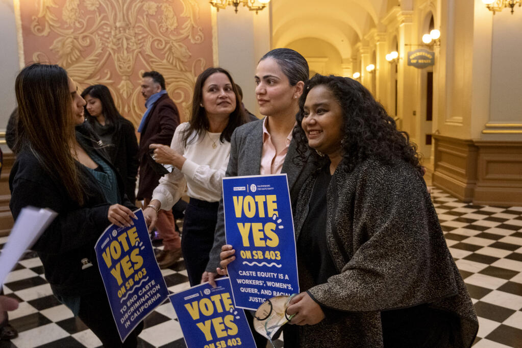 Califiornia state Sen. Aisha Wahab, center, with Thenmozhi Soundararajan, right, following a news conference where she proposed SB 403, a bill which adds caste as a protected category in the state’s anti-discrimination laws, in Sacramento, Calif., Wednesday, March 22, 2023. California may become the first state in the nation to outlaw caste-based bias, a safeguard people of South Asian descent say is necessary to protect them from discrimination in housing, education and the tech sector where they hold key roles. (AP Photo/José Luis Villegas)