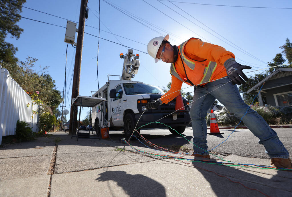 Sonic fiber splicing technician Thai Saengarun works on building Sonic's fiber optic infrastructure to bring high speed internet access to a neighborhood, at Brown and Charles streets, in Santa Rosa on Thursday, October 14, 2021.  (Christopher Chung/ The Press Democrat)