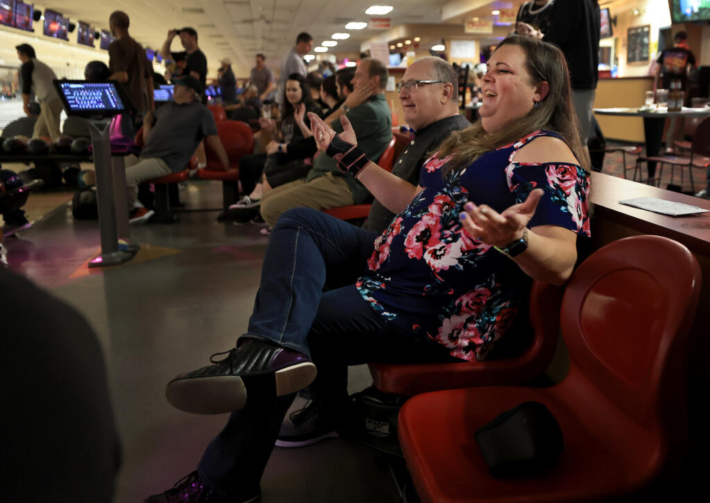 Jennifer Rihl, right, co-chair at TransLife Sonoma County, bowls Thursday, April 21, 2022, with friends, including Jeff Schwartz, at Double Decker Lanes in Rohnert Park. (Kent Porter/The Press Democrat)