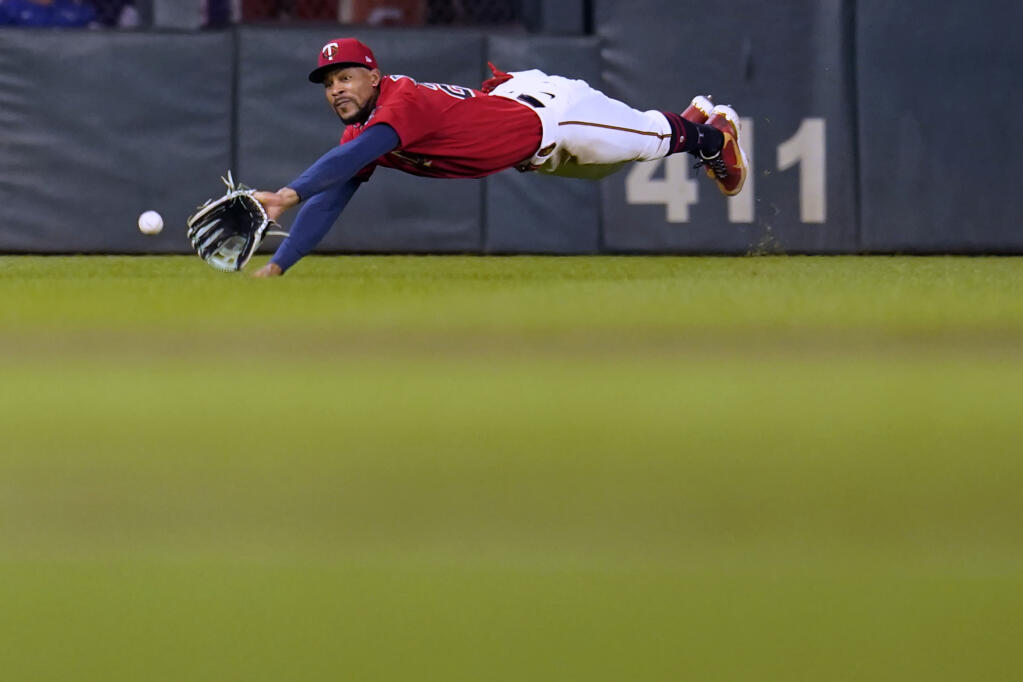 Minnesota Twins center fielder Byron Buxton fails to make the catch on a double hit by Kansas City Royals' Ryan O'Hearn during the ninth inning of a baseball game Monday, Aug. 15, 2022, in Minneapolis. (AP Photo/Abbie Parr)