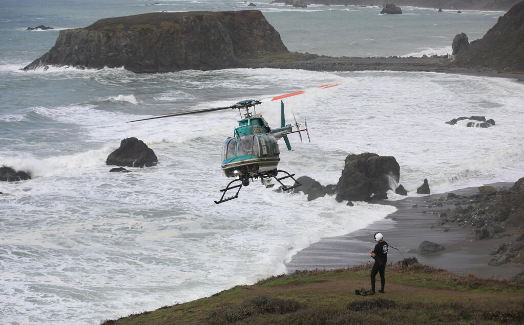 Henry 1, the Sonoma County Sheriff's helicopter team, Monday, Jan. 4, 2021, was called in to help search for two missing children that were swept away in the surf at Blind Beach, right, that also killed their father Sunday afternoon.  Goat Rock is in the background. (Kent Porter / The Press Democrat) 2021