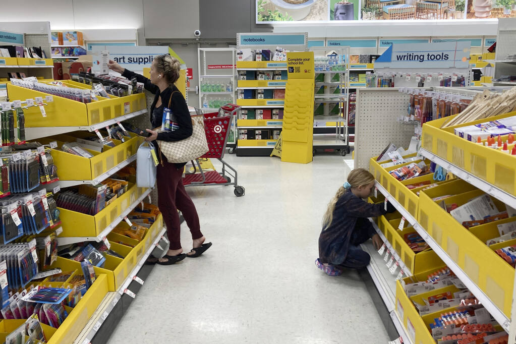 A parent shops for school supplies deals at a Target store, Wednesday, July 27, 2022, in North Miami, Fla. (AP Photo/Marta Lavandier)