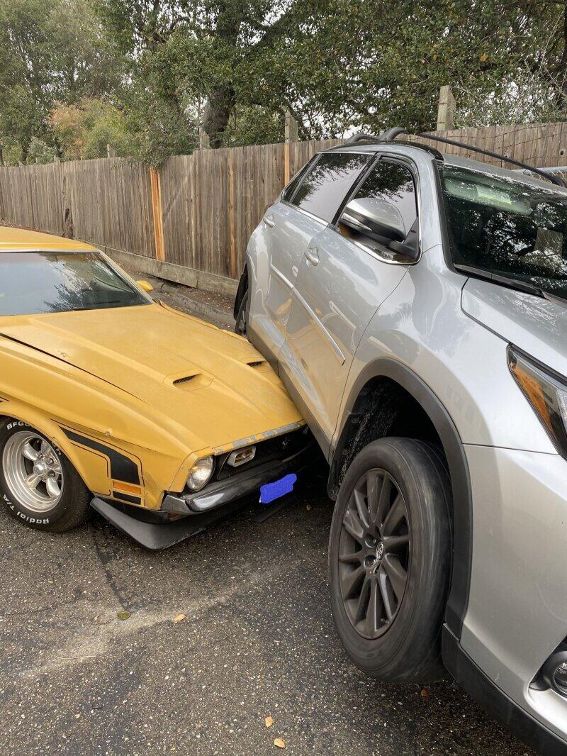 Santa Rosa Police Department officers responded at 9:34 a.m. Friday to the 70 block of West Third Street where they found a gray Toyota Highlander partially resting atop an older model, yellow Ford Mustang. (Santa Rosa Police Department)