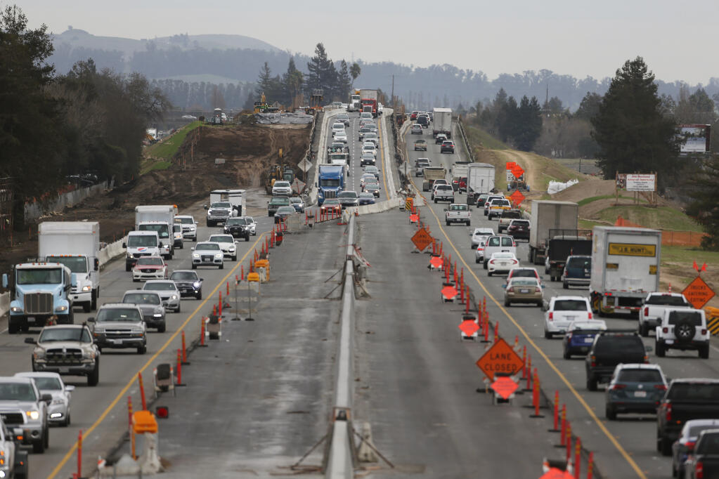 Vehicles travel along a section of Highway 101 between E. Washington St. and Corona Road where construction work is ongoing. Photo taken looking south from the Corona Road overpass in Petaluma, California, on Tuesday, January 26, 2021. (Beth Schlanker/The Press Democrat)