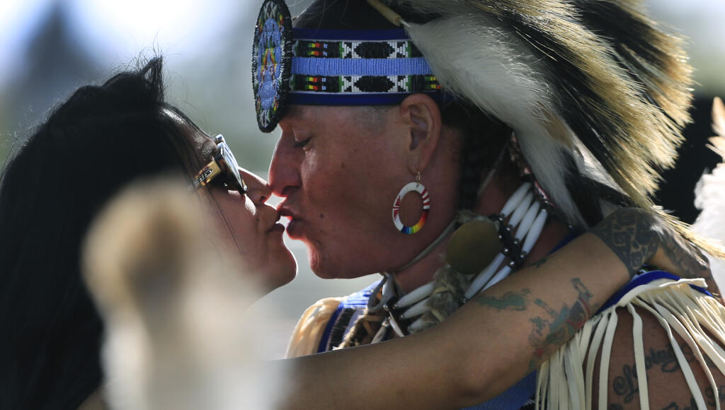 Lucero Vargas and Reuben Crowfeather of Santa Rosa, share a quiet moment during an Indigenous Peoples Gathering at the Sonoma County Fairgrounds in Santa Rosa, Saturday, May 1, 2021. Crowfeather, a Lakota Native American, recently moved to Sonoma County from Standing Rock, South Dakota. (Kent Porter / The Press Democrat) 2021