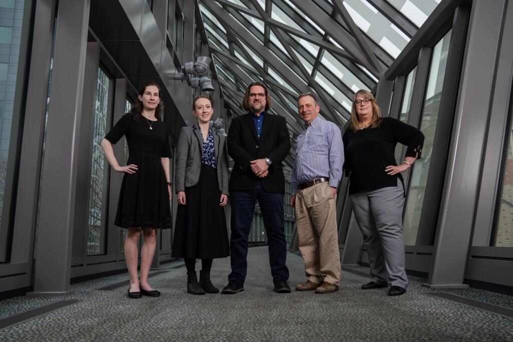 Key members of the new Center for Forecasting and Outbreak Analytics include, from left, Rebecca Kahn, senior scientist; Caitlin Rivers, associate director; Dylan George, operations director; Marc Lipsitch, director for science; and Alison Kelly, deputy director.  (Photo for The Washington Post by Kevin D. Liles)