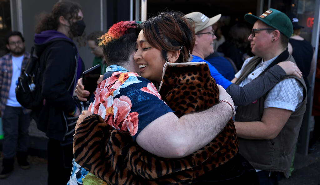 Benji Shiell, left, greets Chantavy Tornado (she/they) on Friday, March 31, at Brew Coffee and Beer House in Santa Rosa as people gather for Transgender Day of Visibility. (Kent Porter / The Press Democrat) 2023