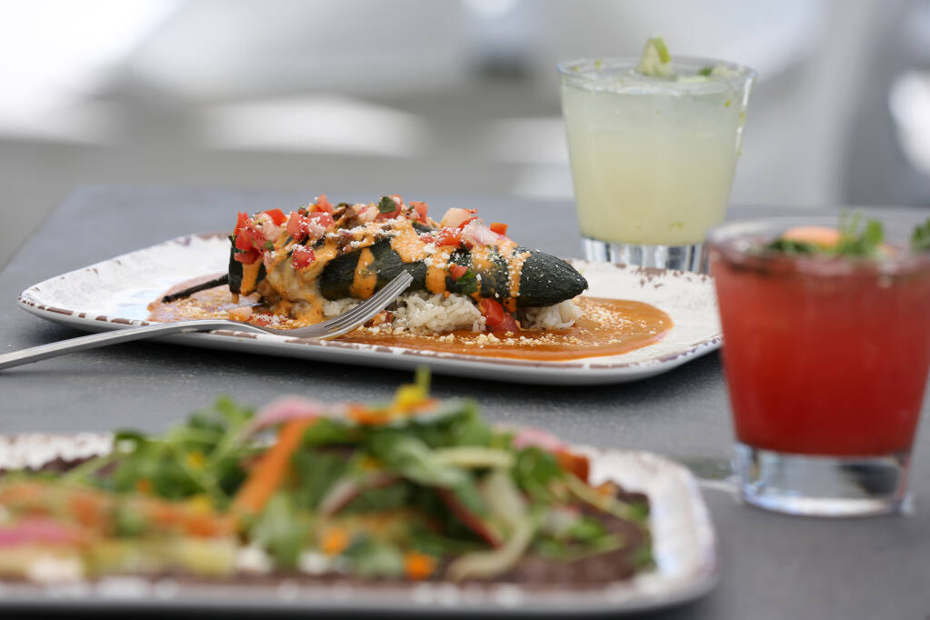 Bison Chile Relleno made with a roasted poblano pepper, free range ground bison, Oaxacan cheese, scallions, rice, chipotle aioli, Pico de Gallo, and Ranchera sauce at C Casa bar and taqueria in Napa, Calif. on Monday, July 18, 2022. (Beth Schlanker/The Press Democrat)