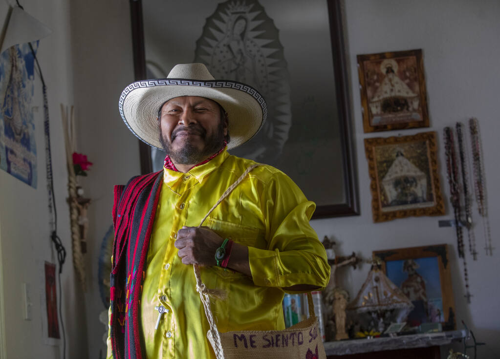 Vineyard worker Fausto Guzman of the Triqui community, at his home in Healdsburg, wearing traditional clothing, celebrates the passing of AB 2183 which creates new ways for farmworkers to vote in a union election, including options for mail-in ballots, and authorization cards submitted to the California Agricultural Labor Relations Board, in addition to the existing in-person voting process, October 3, 2022. (Chad Surmick / The Press Democrat)