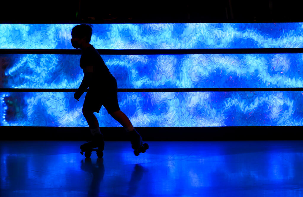 Kaiden Kapple, 8, skates past the new light display in front of the DJ station at Cal Skate in Rohnert Park on Tuesday, Jan. 11, 2022.  (Christopher Chung/ The Press Democrat)