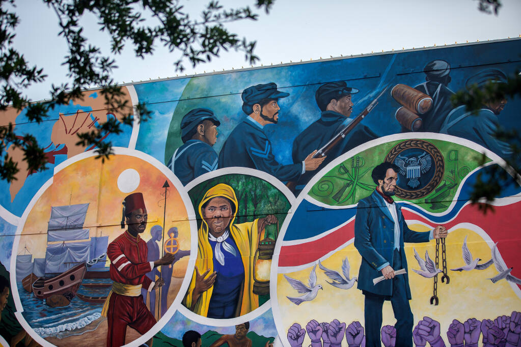 FILE -- A 5,000-square-foot mural created by Reginald C. Adams, at the spot where, in 1865, Gen. Gordon Granger issued the orders that resulted in the freedom of more than 250,000 enslaved Black people in the state, in Galveston, Texas, on May 5, 2021. The U.S. House voted 415-14 Wednesday to make Juneteenth, or June 19th, the 12th federal holiday. The Senate passed the bill a day earlier under a unanimous consent agreement that expedites the process for considering legislation. President Biden is expected to sign the bill into law. (Montinique Monroe/The New York Times)