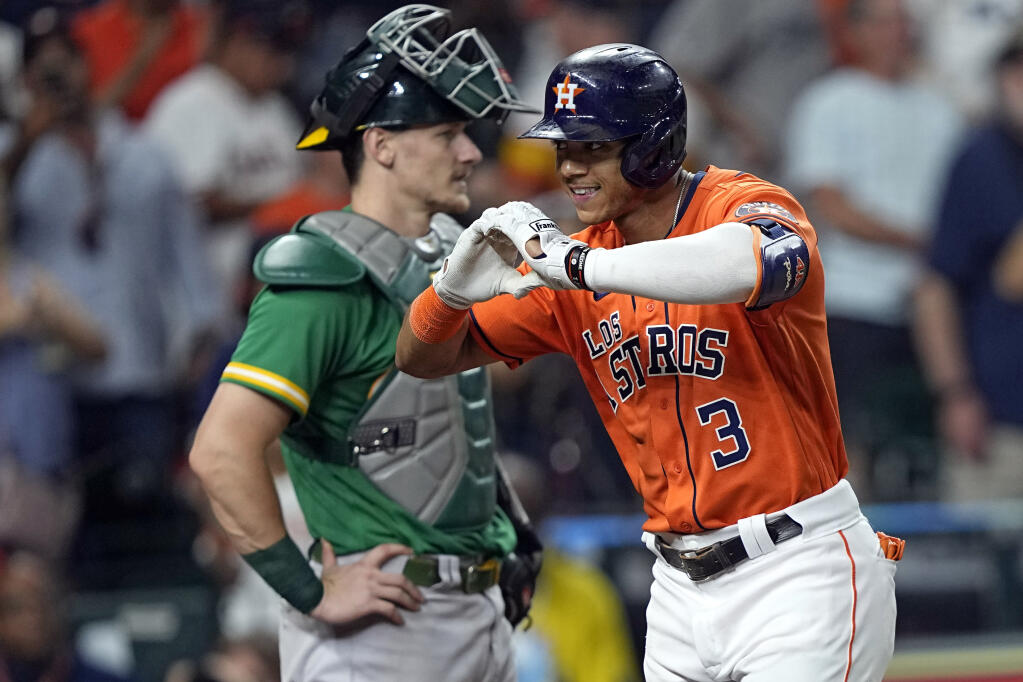 The Astros’ Jeremy Pena celebrates after hitting a home run as A’s catcher Sean Murphy stands behind home plate during the fifth inning Friday, Sept. 16, 2022, in Houston. (David J. Phillip / ASSOCIATED PRESS)