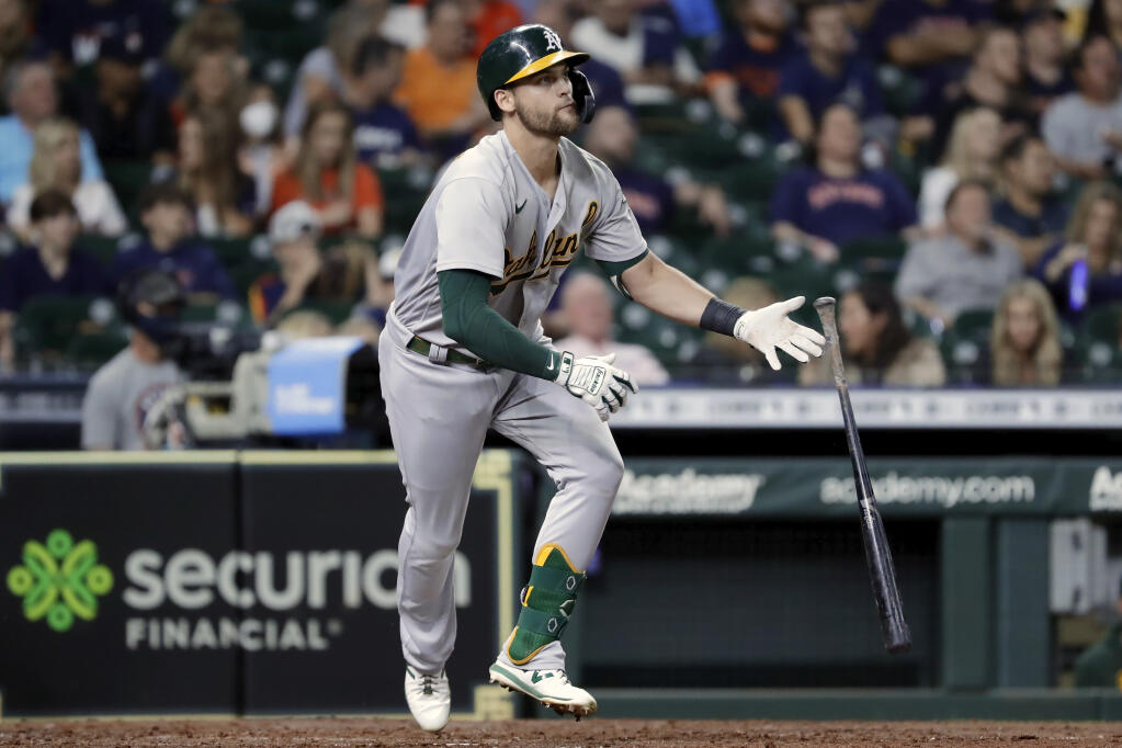 Oakland Athletics' Chad Pinder (4) flips his bat as he rounds the bases on his solo home run against the Houston Astros during the fourth inning of a baseball game Friday, Oct. 1, 2021, in Houston. (AP Photo/Michael Wyke)