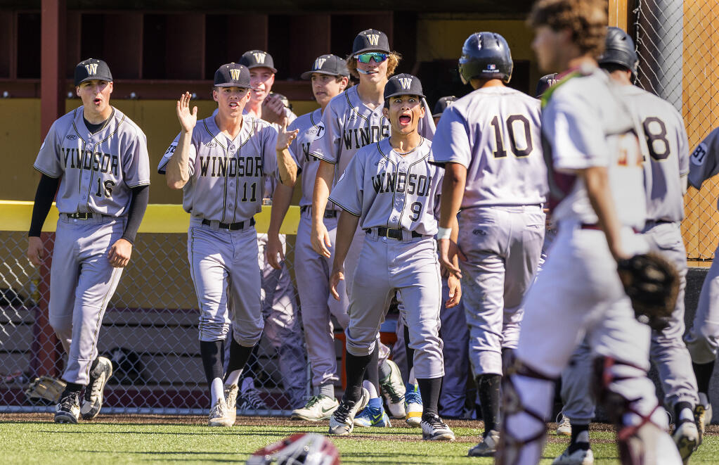 The Windsor bench cheers on Joseph Soltanizadeh (No. 10) after he scored in the first inning against first-place Cardinal Newman on Tuesday, May 3, 2022. (John Burgess/The Press Democrat)
