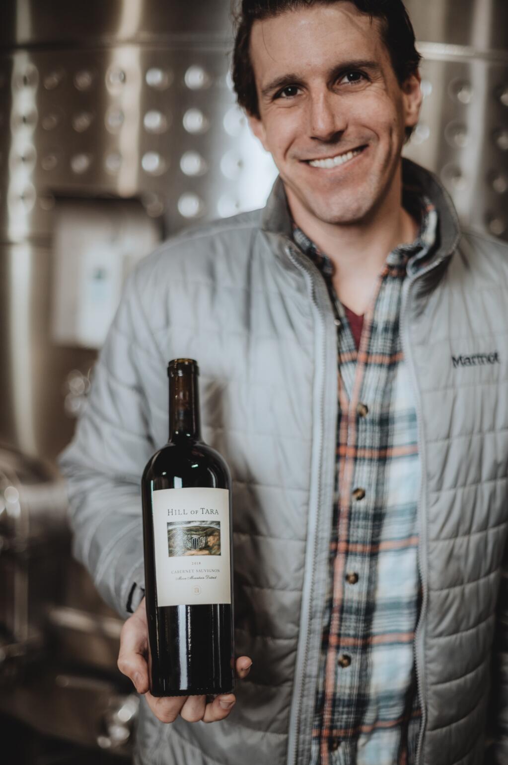 Alex Kanzler holds a bottle of 2018 Hill of Tara wine, his first vintage with the winery. (courtesy of Hill of Tara Wines)